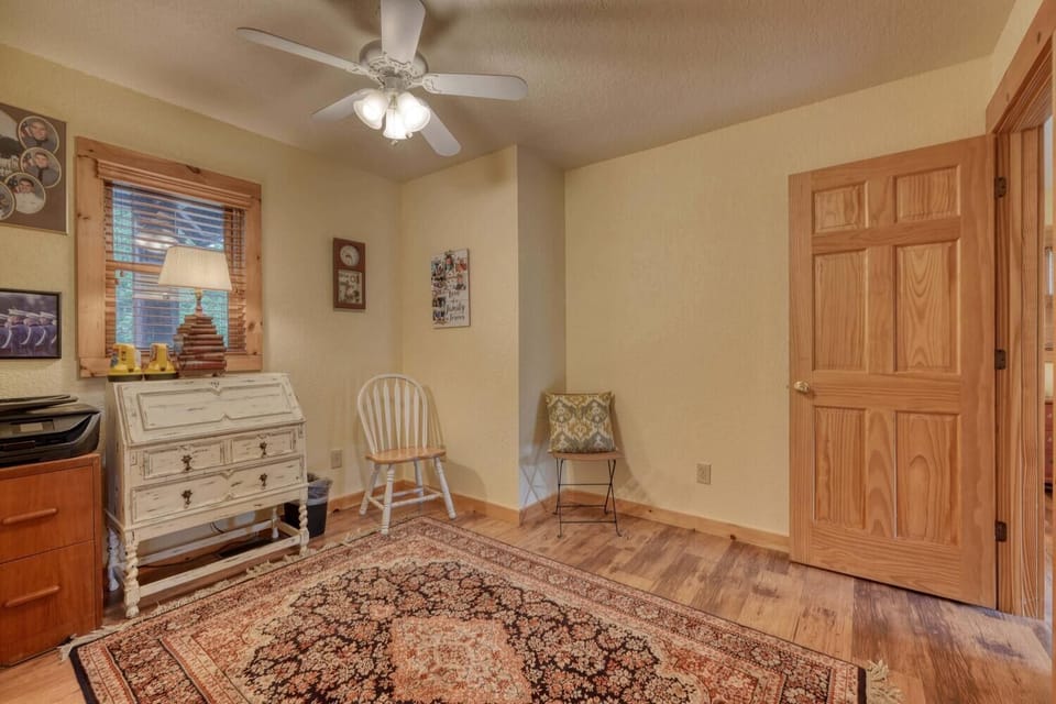 "Bright, functional space with a desk, cozy seating, and natural light."