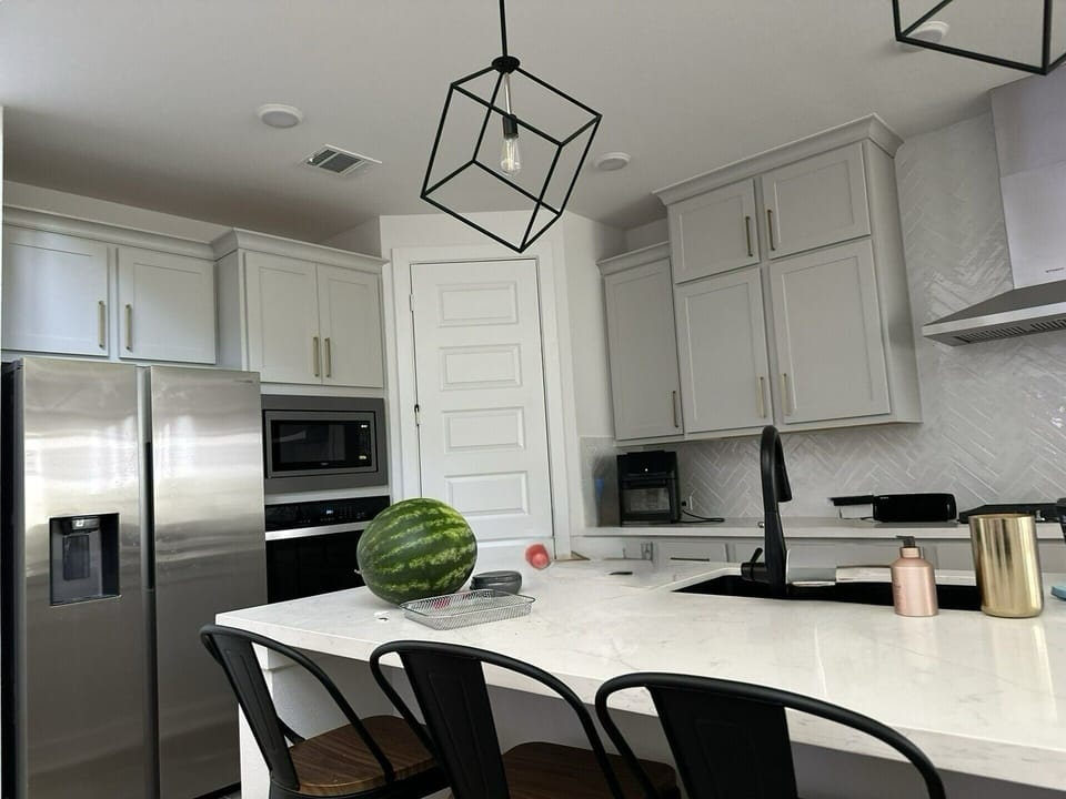 refrigerator, spacious island, dishwasher, oven, stove, microwave