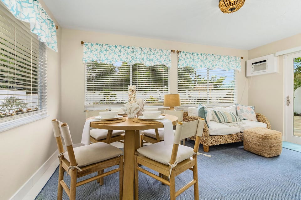 Dine with a view! This charming dining area offers a glimpse of the outdoors, creating a peaceful and refreshing atmosphere for your meals.  Enjoy the natural light and the serene ambiance.