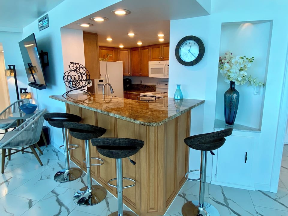 Open kitchen with breakfast bar seating for four.  