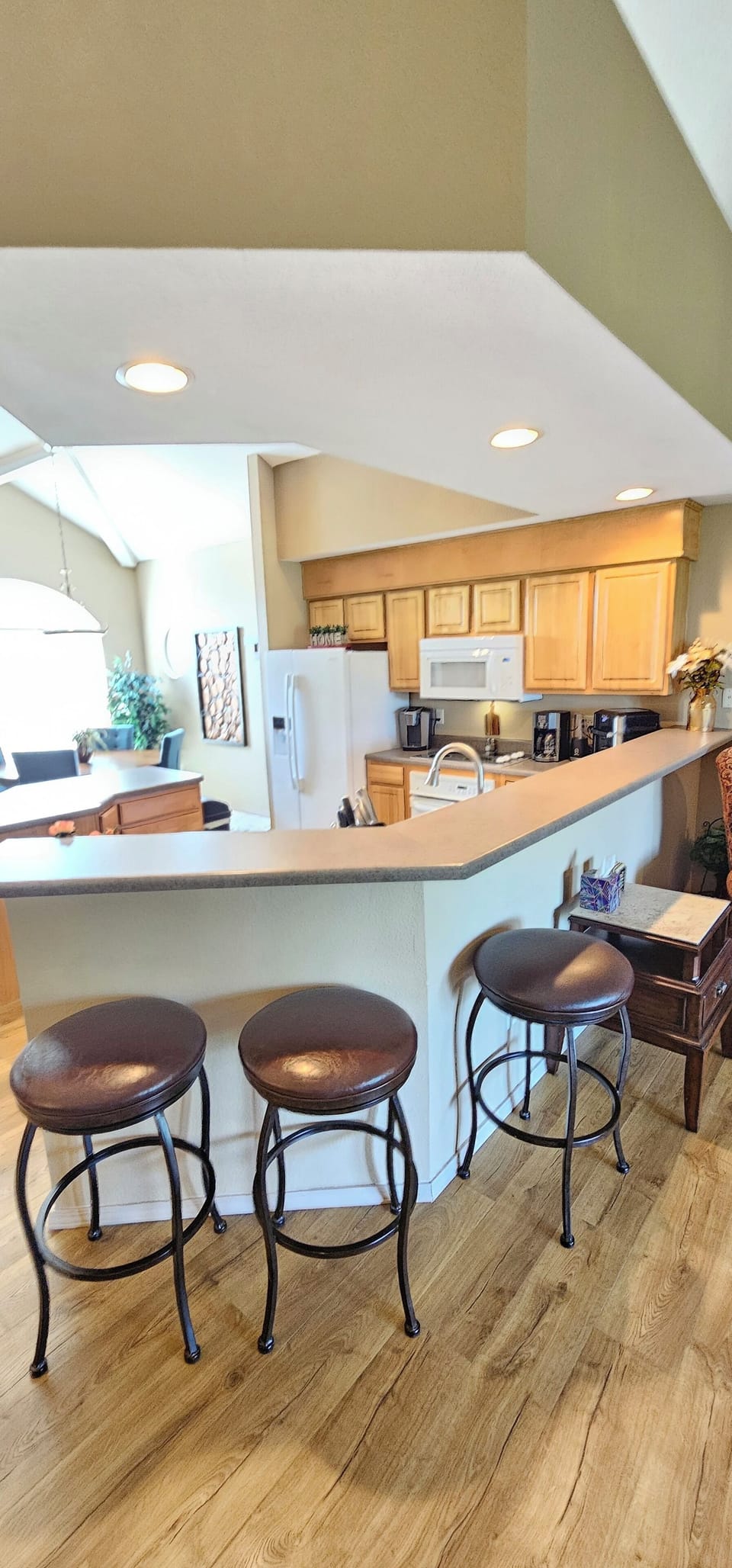 Breakfast bar, cushioned bar swivel seating & an amazing view of the bay window!