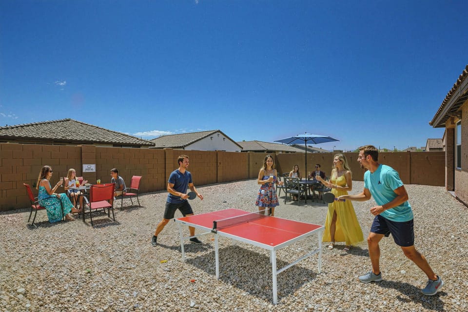 Outdoor Private Yard with a 6 person dining area, separate lounging area, and fun ping pong table.