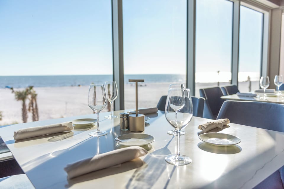 Savor beachfront cocktails as sunlight sparkles on the water.