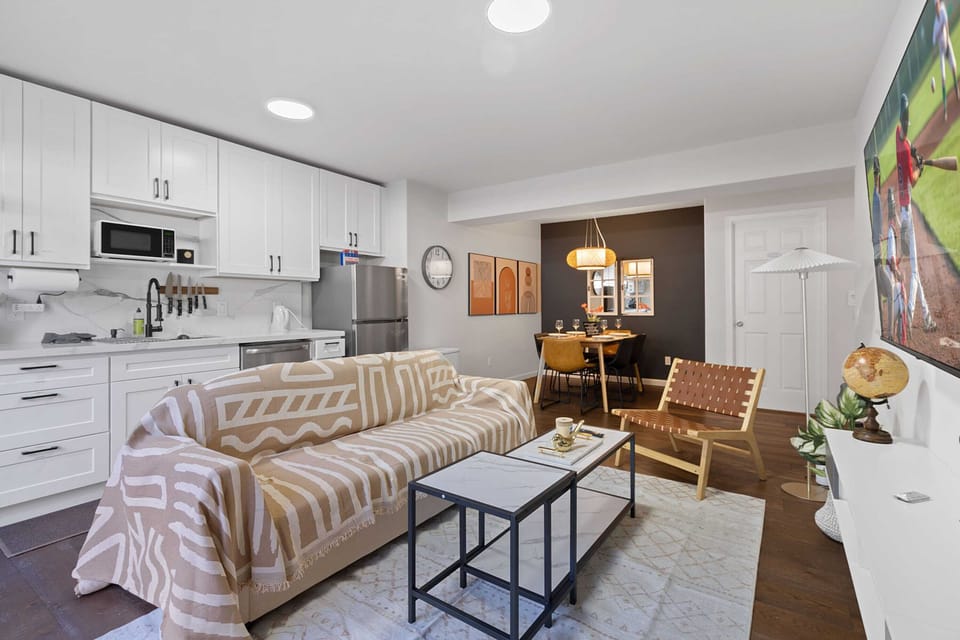 Bright and cozy living room with modern decor, perfect for relaxing after a day of exploring the city.