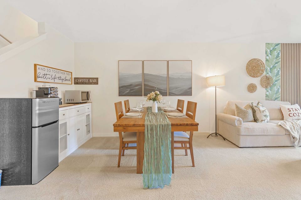 The dining area, adjacent to a handy kitchenette, provides everything you need for a comfortable stay, from quick breakfasts to cozy dinners.