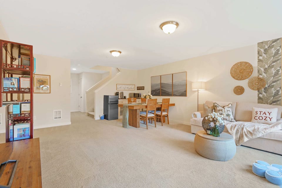 Unwind in the cozy reading nook with a selection of books and a comfortable seating area, perfect for some quiet time.