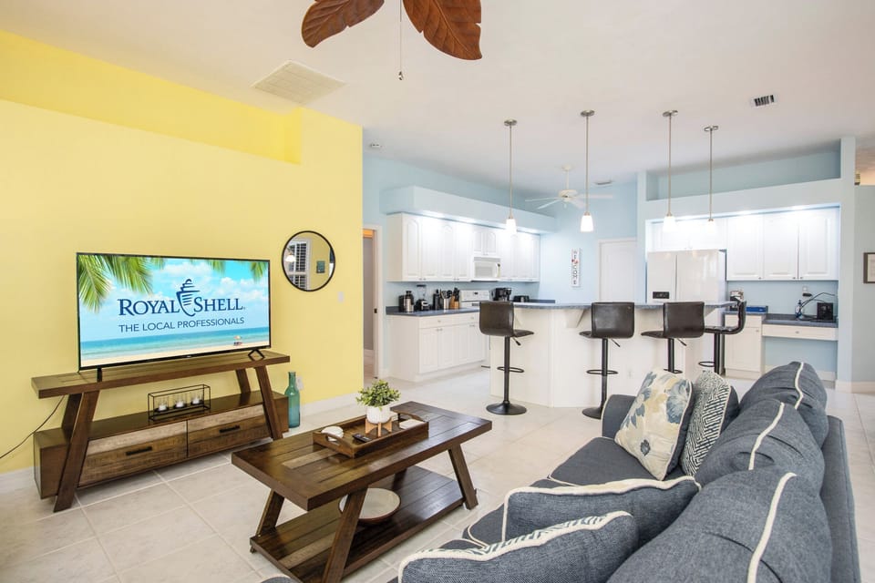 This inviting den offers modern entertainment with a smart TV and flows openly into the kitchen and dining spaces, perfect for socializing