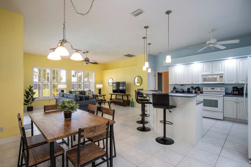 This open-concept layout seamlessly connects the kitchen, dining area, and den — perfect for entertaining and togetherness