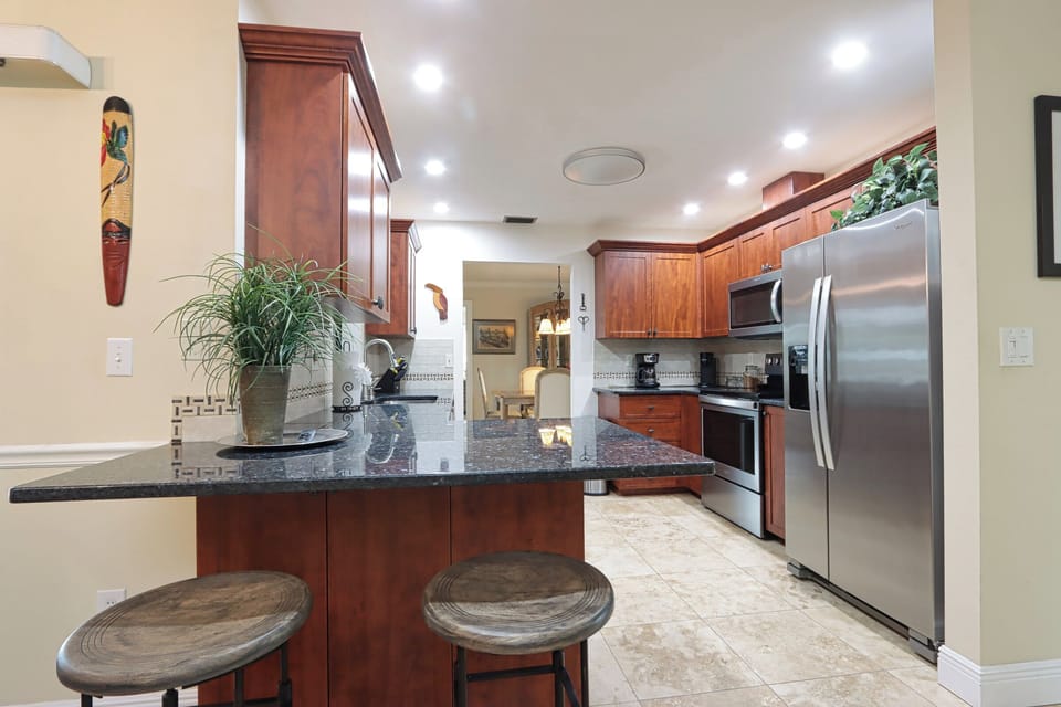 Kitchenwith stainless appliances and granite countertops