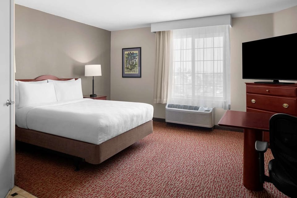 Unwind in a bright bedroom with plush, crisp linens.