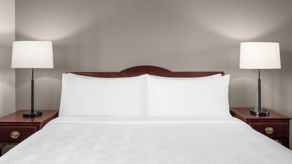 Drift off with plush pillows and calming bedside glow.