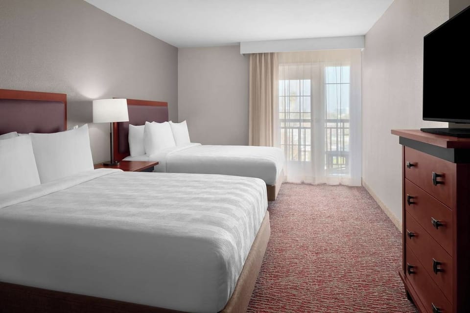 Stretch out in a bright bedroom with balcony views.
