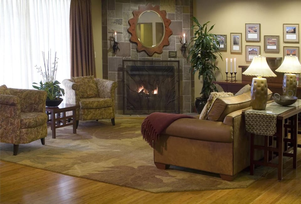 Unwind by the glowing fireplace in a cozy lounge setting.