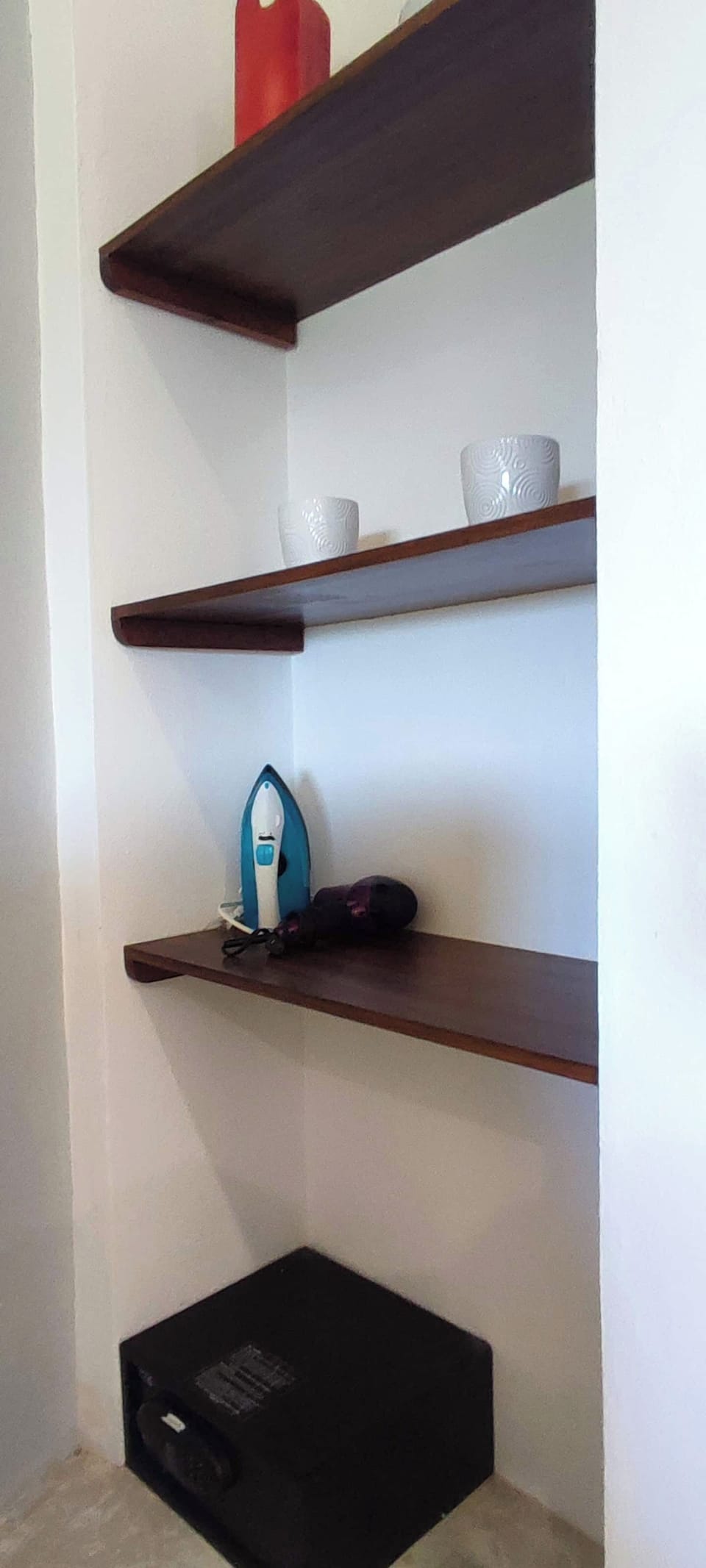 Room equipped with a safe, hairdryer, and iron