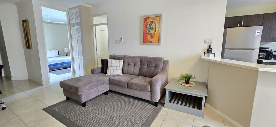 Cozy living area w/ plush sectional sofa & open pass-through to the kitchen for easy conversation