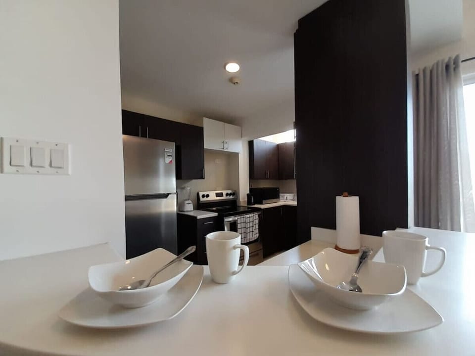 Dining table set for four beside the kitchen—an inviting spot to gather for meals or morning coffee