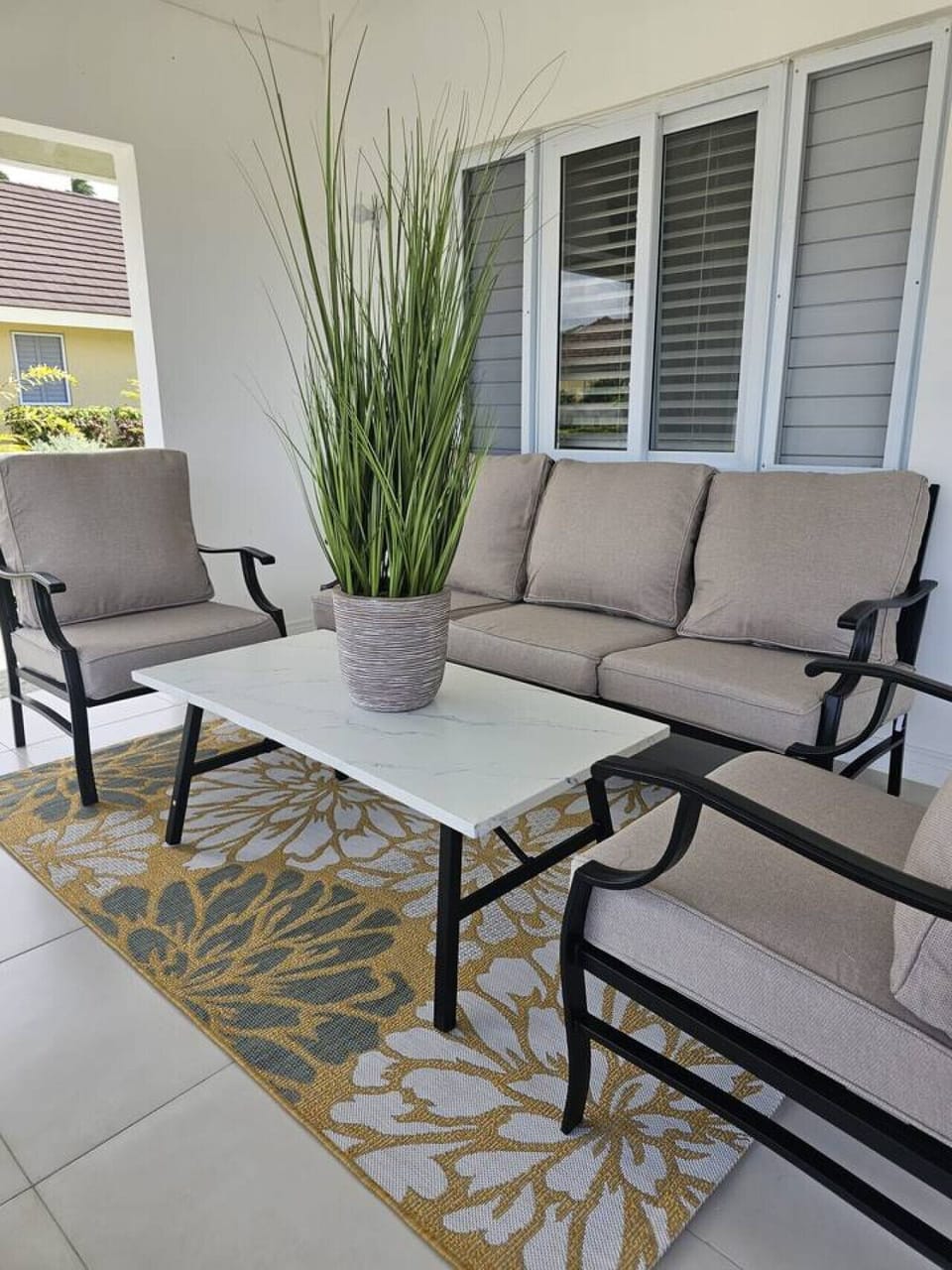 Relax on the covered patio w/ cushioned seating and a coffee table—ideal for morning coffee or evening chats.
