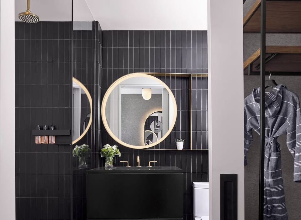 Rejuvenate under a rainfall shower in a sleek, spa-like bath.