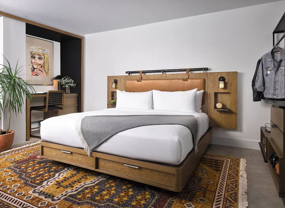 Unwind into crisp linens on a warm, modern king bed.