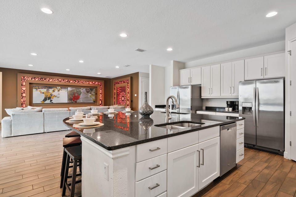 - Large kitchen with granite countertops and bar seating
- Fully equipped vacation home for family dining needs
- Orlando rental with open living and modern kitchen