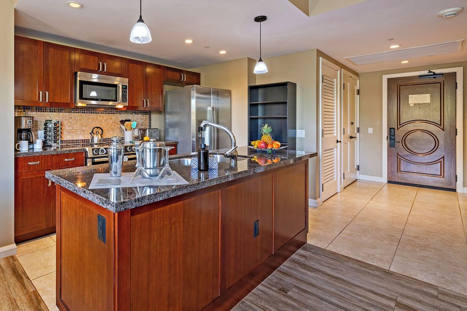 The kitchen at Honua Kai Konea 232 boasts a modern design and spacious, user-friendly layout.