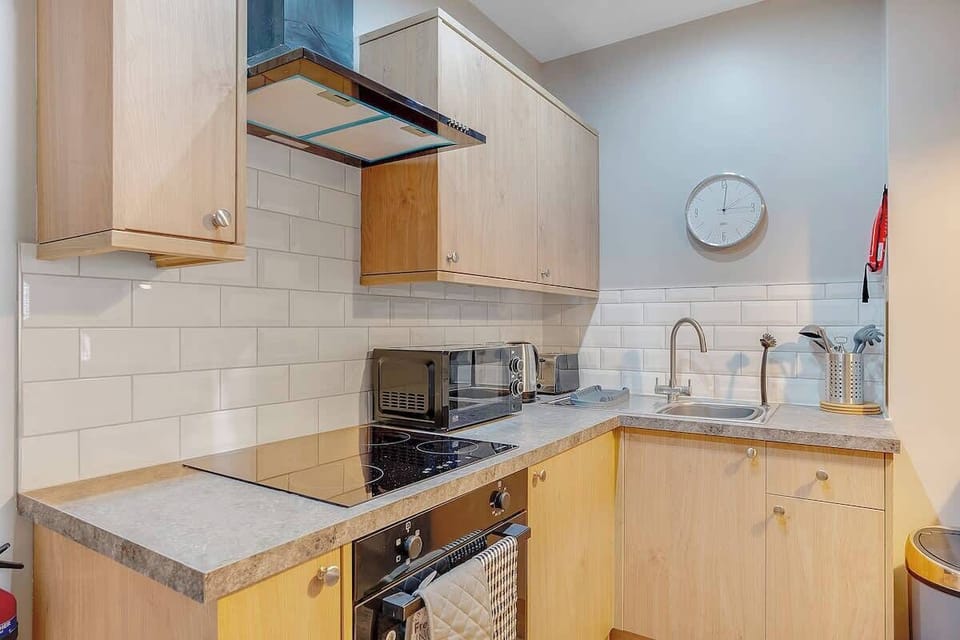 Featuring sleek finishes and a welcoming breakfast bar, the kitchen comes complete with an electric hob, oven, microwave, fridge/freezer, washer and all your cooking essentials.