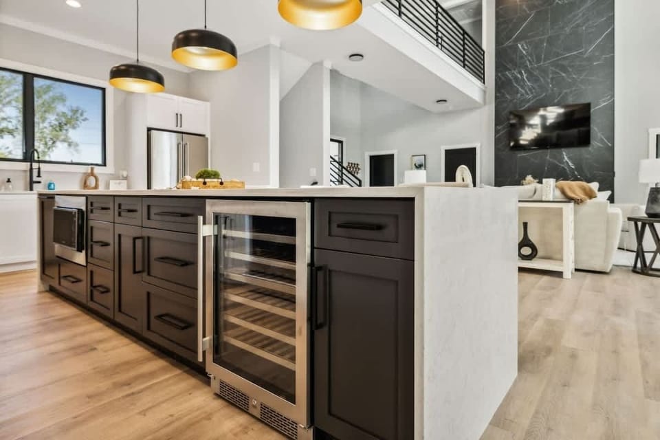 Fully stocked kitchen, quartz waterfall edge cabinets.