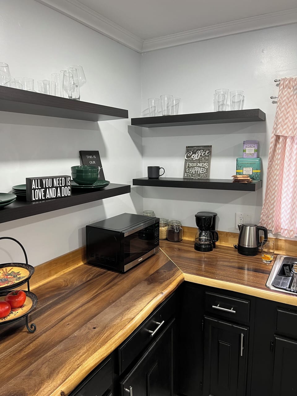Fully stocked kitchen with coffee maker, tea, kettle, microwave, and air fryer