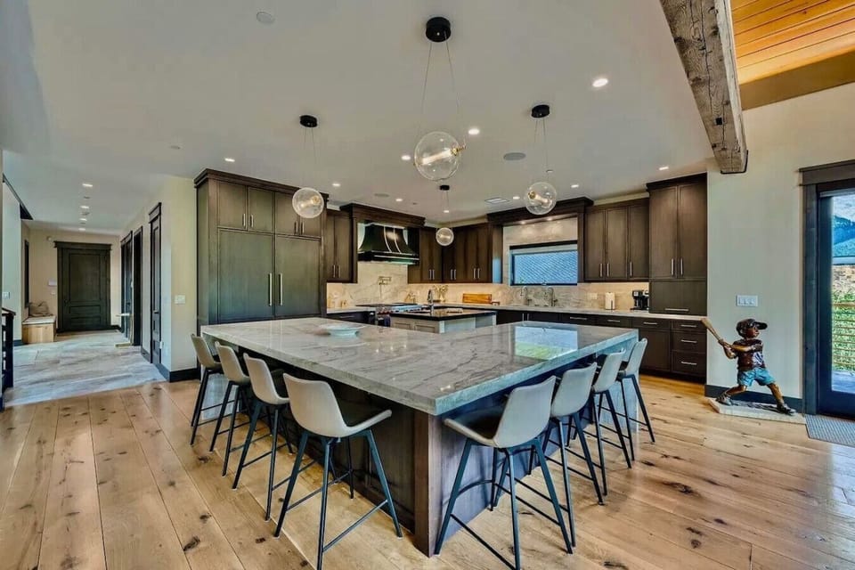 Cook and entertain in this spacious, fully-equipped kitchen featuring a large island, sleek finishes, and top-of-the-line appliances—perfect for family meals and gatherings.
