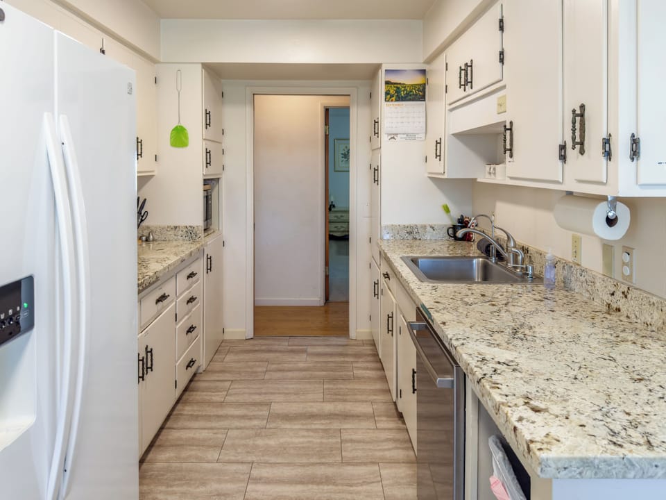 Kitchen second sink and dishwasher, off of bedroom 3, bath 3 to the right