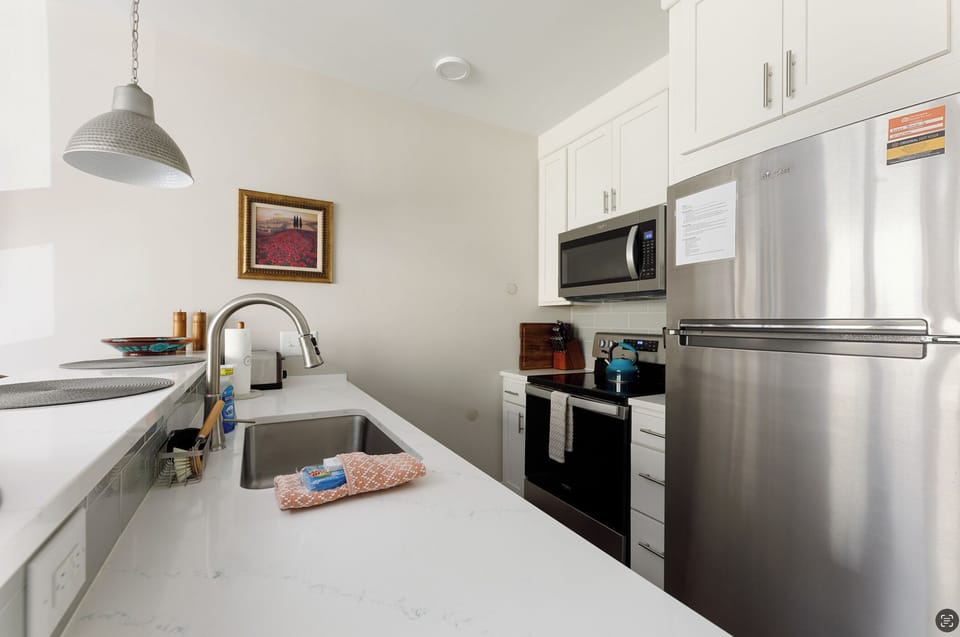 Our kitchen is designed for both cooking and socializing, with a spacious countertop and bar seating.