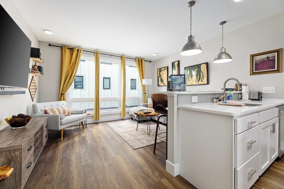 The open concept design allows for a flowing conversation between the kitchen and living areas