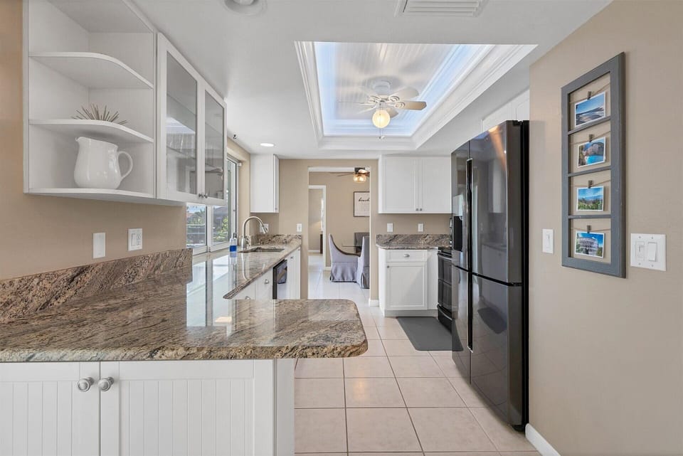 Fully-equipped kitchen with gorgeous view of pool and canal beyond