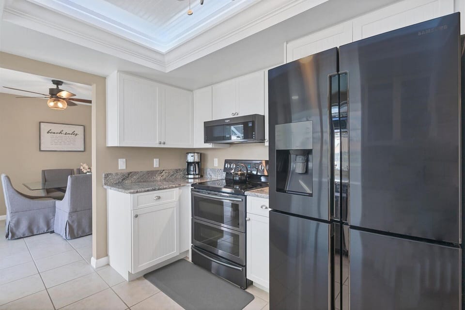 Fully-equipped kitchen with gorgeous view of pool and canal beyond