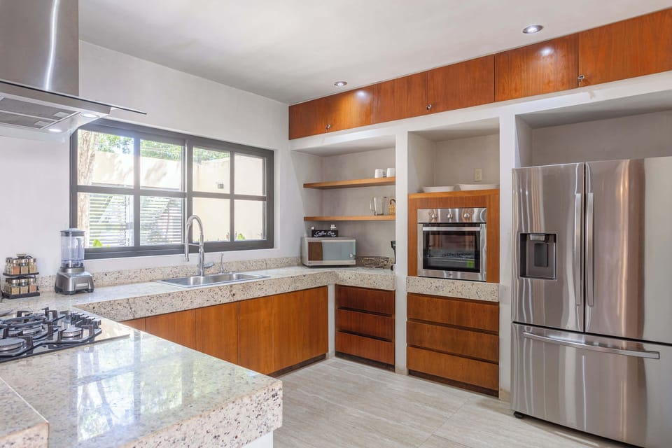 The fully equipped kitchen features high-quality stainless steel appliances and everything you need to prepare meals at home