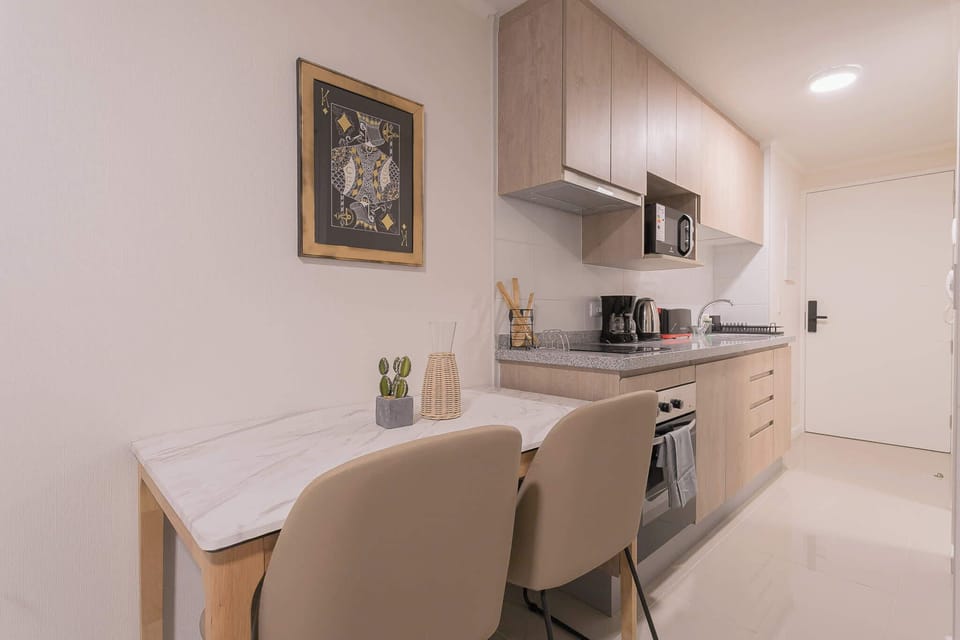 Cozy and modern kitchen with dining area, perfect for intimate meals and culinary adventures.
