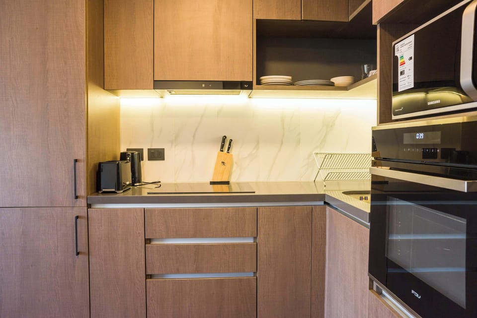 Sleek and modern kitchen with top appliances and ample storage, perfect for cooking your favorite meals.
