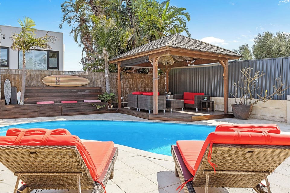 Beautiful pool with sun loungers and undercover Bali Cabana