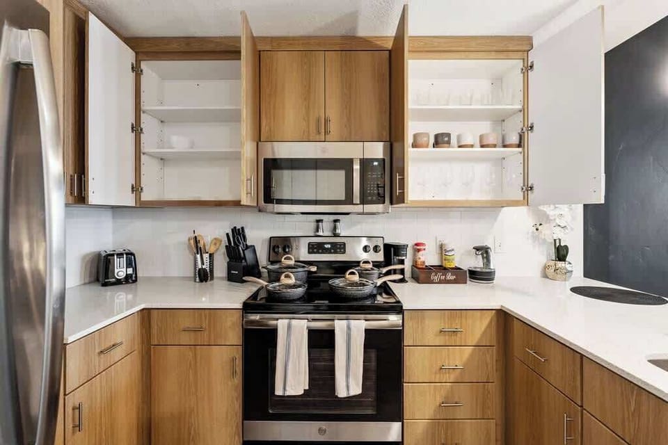 Enjoy the convenience of a well-equipped kitchen with a bar counter, dishwasher, and full set of utensils.