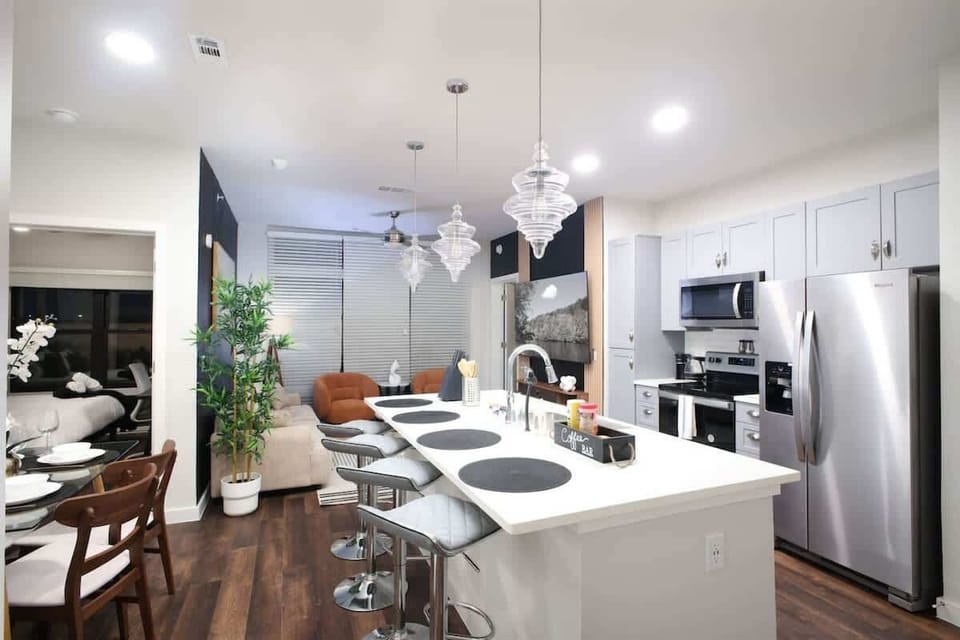 Our kitchen offers everything you need for a perfect meal, from a full set of utensils to a sleek bar counter with high stools.
