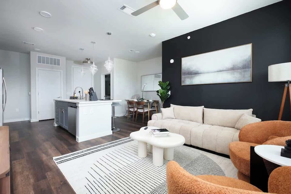 Our living room invites you to relax and enjoy, with soft sofas, natural light, and a touch of art and nature.