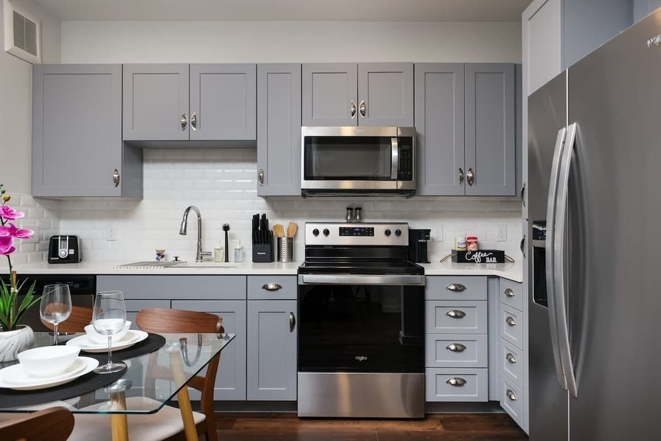 Experience the convenience of a fully-stocked kitchen, with a bar counter, coffee maker, and a fresh touch of mini plants.