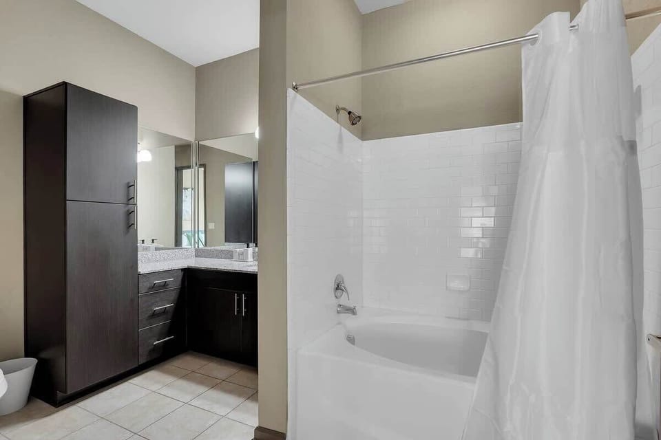 Relax and unwind in our full bathroom featuring a luxurious bathtub, modern vanity, and toilet.