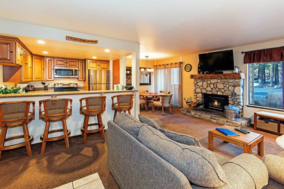 Living room w/ TV, DVD player, wood burning fireplace