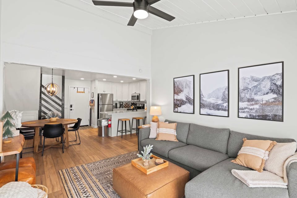 Living room with TV, gas fireplace, balcony access, and sofa sleeper