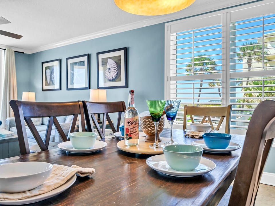 Gather around this elegant dining table where coastal charm meets comfort, creating the perfect setting for your vacation meals.