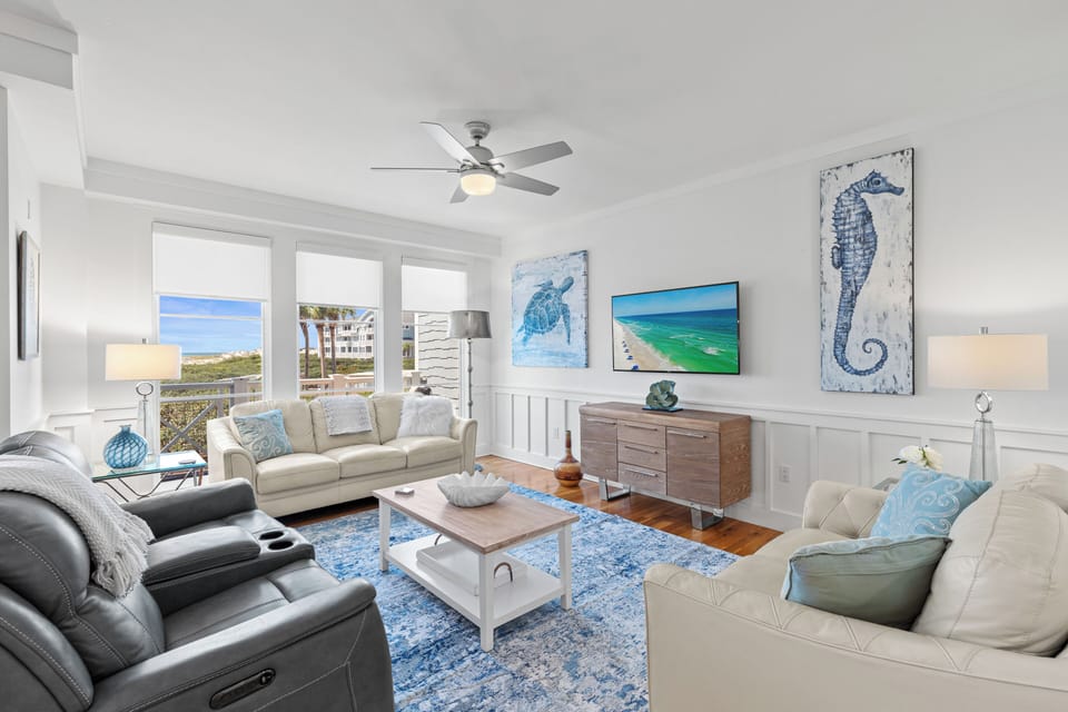 Unwind in your coastal-themed living room where ocean-inspired art meets comfort, with stunning beach views through your windows.