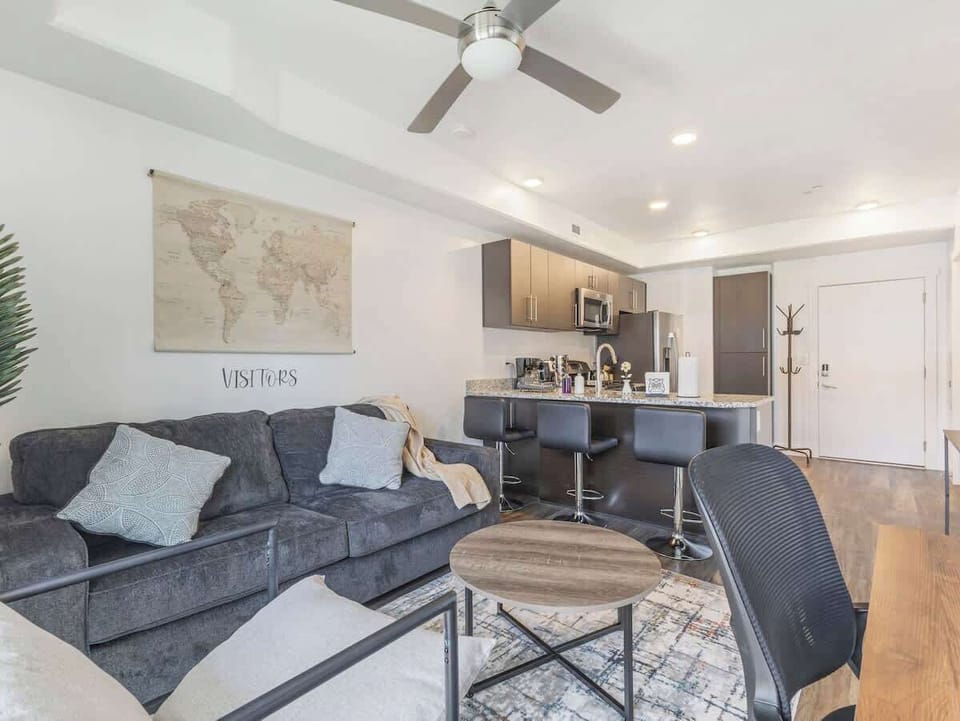 Comfortable living space w/ bar seating connecting to modern kitchen
