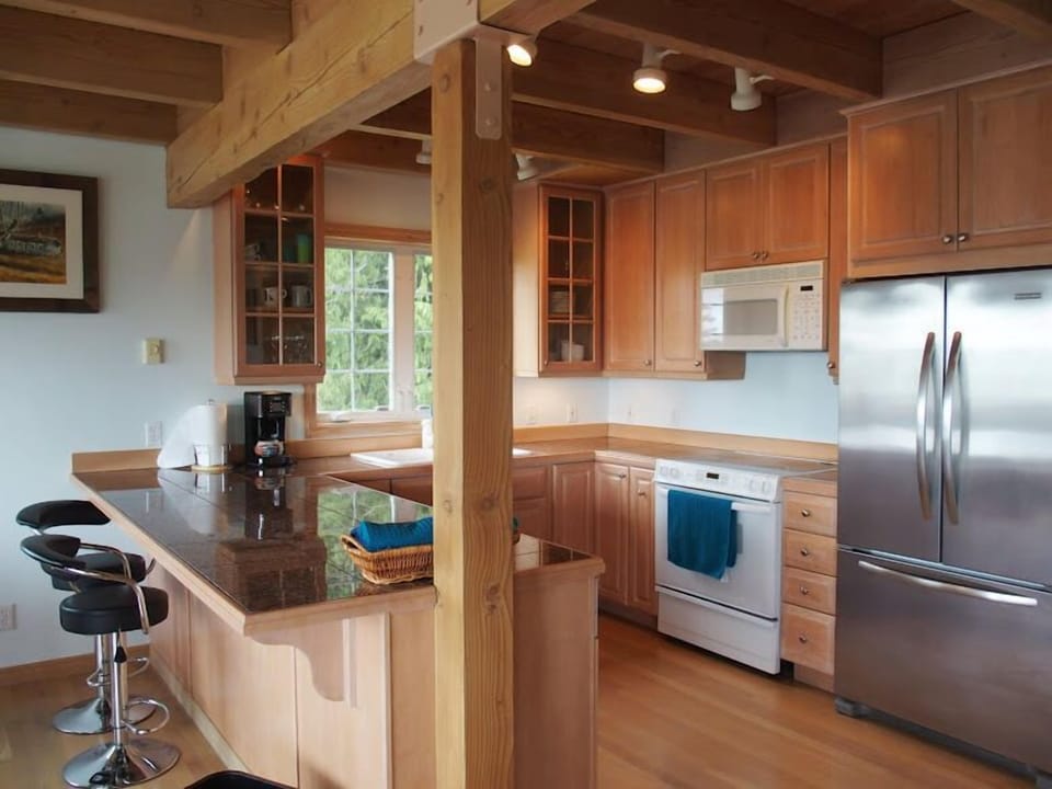 Open concept kitchen allows you to cook like a chef, engage with your party, and soak in the views