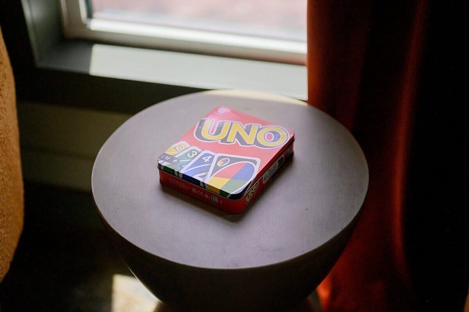 UNO card game on a modern side table, offering cozy indoor entertainment in a cabin retreat. Fun board games for families and kids during your mountain getaway stay.